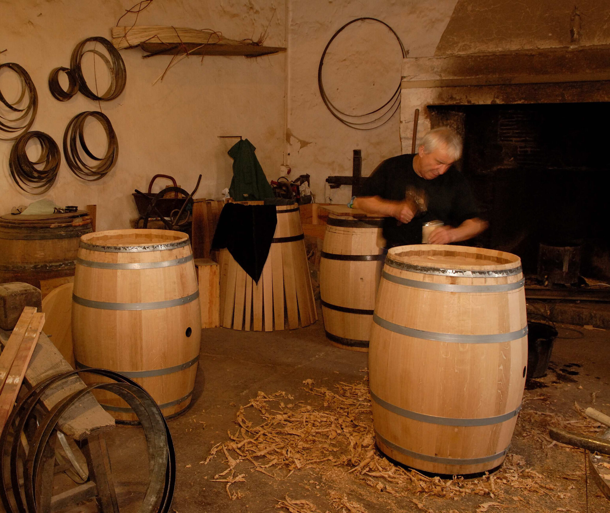 A French cooper shaping a wine barrel by hand