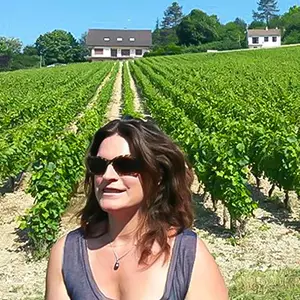 Marie Tesson in vineyard founder of Exclusive France Tours